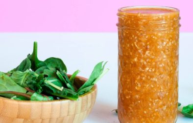 jar of sesame ginger sauce with leafy greens